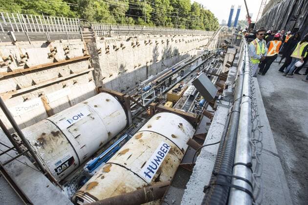 Sept. 24, 2015 - Toronto, ON, Canada - TORONTO, ON - SEPTEMBER 24 - Workers look at two large boring machines on Eglinton Ave. East, where they will soon begin boring toward Yonge St. The Crosstown is a light rail transit (LRT) line that will run across Eglinton Avenue between Mount Dennis (Weston Road) and Kennedy Station. This 19-kilometre corridor will include a 10-kilometre underground portion, between Keele Street and Laird Drive. September 24, 2015. Toronto Canada  - ZUMAt14_