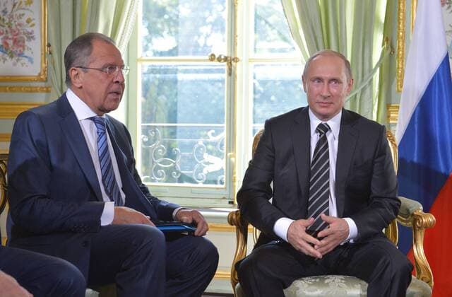 PARIS, FRANCE. OCTOBER 2, 2015. Russia s Foreign Minister Sergei Lavrov (L) and Russian President Vladimir Putin seen during a meeting with French President Francois Hollande (not pictured) ahead of Ukraine peace talks at the Elysee Palace in Paris. Alexei Druzhinin Russian Presidential Press and Information Office TASS  TS00EE62
