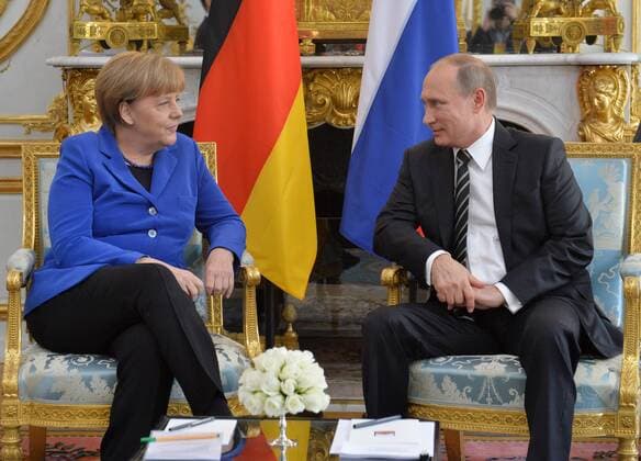 PARIS, FRANCE. OCTOBER 2, 2015. German Chancellor Angela Merkel (L) and Russian President Vladimir Putin hold a bilateral meeting ahead of Ukraine peace talks at the Elysee Palace in Paris. Alexei Druzhinin Russian Presidential Press and Information Office TASS  TS00EE83