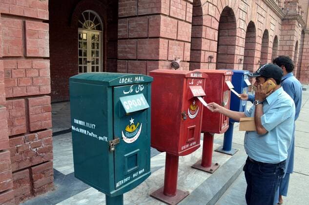 (151009) -- LAHORE, Oct. 9, 2015 -- Pakistani people post letters in a mailbox on the World Post Day in eastern Pakistan s Lahore, Oct. 9, 2015. World Post Day is celebrated each year on Oct. 9, the anniversary of the establishment of the Universal Postal Union (UPU) in 1874 in Berne, the Swiss capital. ) PAKISTAN-LAHORE-WORLD POST DAY JamilxAhmed 