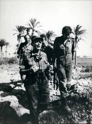 Yom Kippur War 1973: Moshe Dayan on the Egyptian side of the Suez Canal - eating dates. Credit: Nachum Gutman: - ZUMAk09_