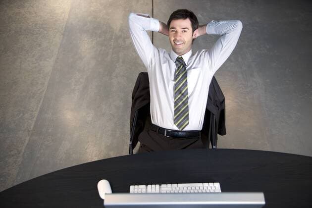 Confident businessman sitting at desk model released Symbolfoto property released  TOYF001166