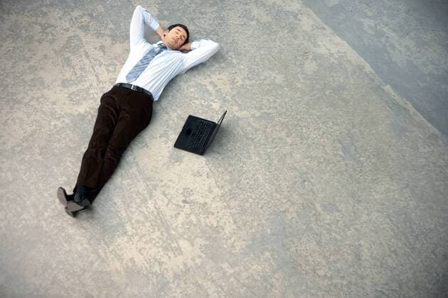 Businessman lying on floor next to laptop model released Symbolfoto property released  TOYF001242