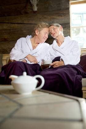 Relaxed senior couple sitting on bench in bathrobes model released Symbolfoto property released  TOYF001288