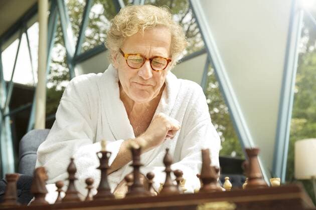 Senior man in bathrobe playing chess model released Symbolfoto property released  TOYF001300
