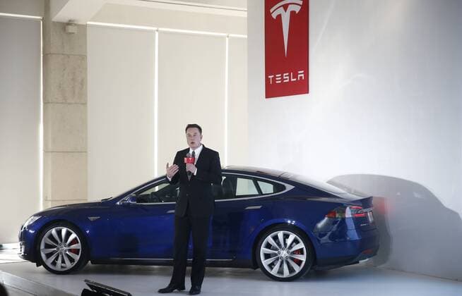 BEIJING, CHINA - OCTOBER 23: (CHINA OUT) Elon Musk, Chairman, CEO and Product Architect of Tesla Motors, addresses a press conference to declare that the Tesla Motors releases v7.0 System in China on a limited basis for its Model S, which will enable self-driving features such as Autosteer for a select group of beta testers on October 23, 2015 in Beijing, China. The v7.0 system includes Autosteer, a new Autopilot feature. While it s not absolutely self-driving and the driver still need to hold the steering wheel and be mindful of road conditions and surrounding traffic when using Autosteer. When set to the new Autosteer mode, graphics on the driver s display will show the path the Model S is following, post the current speed limit and indicate if a car is in front of the Tesla.  CFP474763533