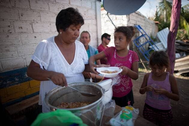 A woman serves food after the passage of hurricane Patricia, in La Huerta, Jalisco state, Mexico, on Oct. 24, 2015. Several municipalities in the western Mexican state Jalisco on the Pacific coast on Saturday were still on alert as Hurricane Patricia lashed further inland and weakened to a tropical storm. Pedro Mera) (da) (fnc) MEXICO-LA HUERTA-ENVIRONMENT-HURRICANE e PEDROxMERA 