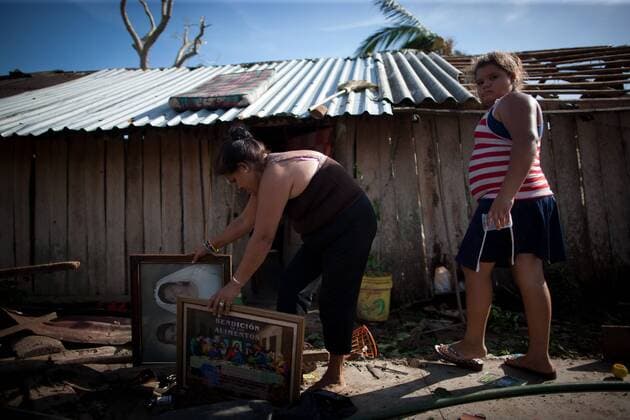 A woman moves pictures after the passage of hurricane Patricia, in La Huerta, Jalisco state, Mexico, on Oct. 24, 2015. Several municipalities in the western Mexican state Jalisco on the Pacific coast on Saturday were still on alert as Hurricane Patricia lashed further inland and weakened to a tropical storm. Pedro Mera) (da) (fnc) MEXICO-LA HUERTA-ENVIRONMENT-HURRICANE e PEDROxMERA 