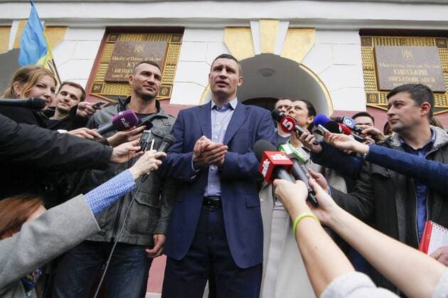 Oct. 25, 2015 - Kiev, Ukraine - Kiev s current mayor and former heavyweight boxing champion Vitali Klitschko, right, his wife Natalia Klitschko, center, and his brother boxing heavyweight world champion Wladimir Klitschko vote at a polling station in an regional and local elections in Kiev, Ukraine, Sunday, Oct. 25, 2015. Polling stations opened in Ukraine on Sunday for regional and local elections across the country, except for the separatist-held regions in the east. According to local media, Kiev s current mayor and former heavyweight boxing champion Vitali Klitschko is expected to win in the capital. Kiev Ukraine - ZUMAf321