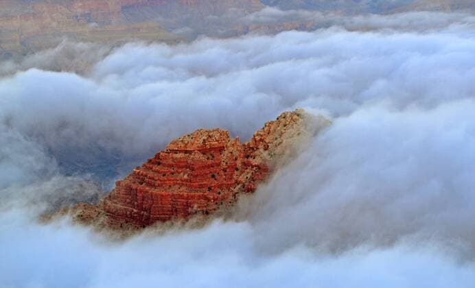 Dec. 12, 2014 - Grand Canyon, AZ, United States of America - Total cloud inversion looking Desert View from the South Rim December 12, 2014 in Grand Canyon National Park, Arizona. The rare phenomenon is caused when the ground loses heat rapidly at dawn to create a layer of cool, damp air inside the canyon, trapping it beneath the unusually warmer sky above the canyon walls and filling the space with a sea of fog. Park officials said the phenomenon is a once-in-a-decade occurrence. Grand Canyon United States of America - ZUMAp138