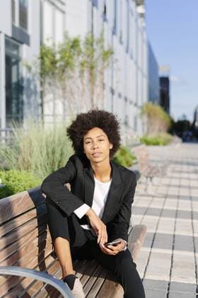 USA, New York City, businesswoman relaxing on a bench  GIOF000187