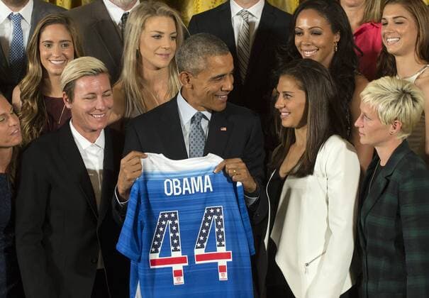 U.S. President Barack Obama talks with Carli Lloyd (R) and Abby Wambach (L) as he holds a team jersey while honoring the U.S. Women s 2015 World Cup champion team at an event in the East Room of the White House in Washington DC on October 27, 2015. Obama said they inspired millions of girls to dream bigger .  WAP2015102705 PATxBENIC