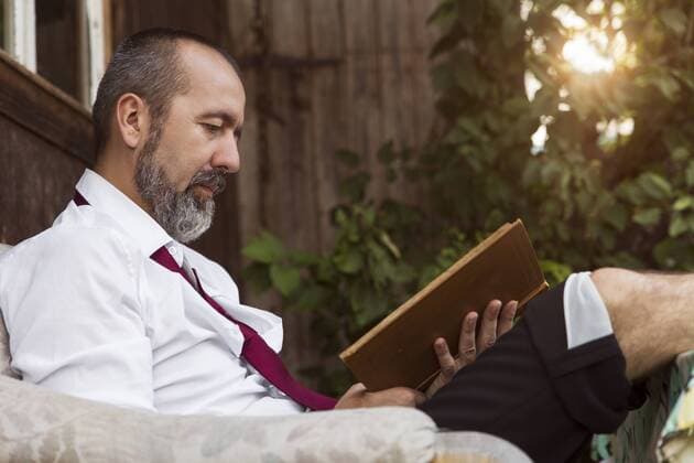 Businessman reading book in the country model released Symbolfoto  MIDF000617