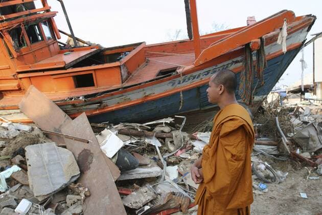 eye ubiquitous religious subjects thailand, phang nga district, nam khem, tsunami. monk looks at the damage caused by the tsunami nothing is left standing in the village 2500 people are pressumed dead. 125kms north of phuket on the 2nd jan. Copyright: 904_05_20094996