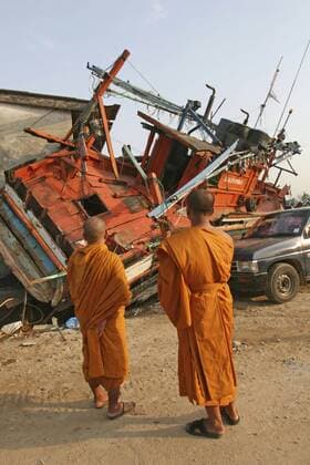 thailand, phang nga district, nam khem, tsunami. monks looks at the damage caused by the tsunami, nothing is left standing in the village 2500 people are pressumed dead. 125kms north of phuket on the 2nd jan. Copyright: 904_05_20095041
