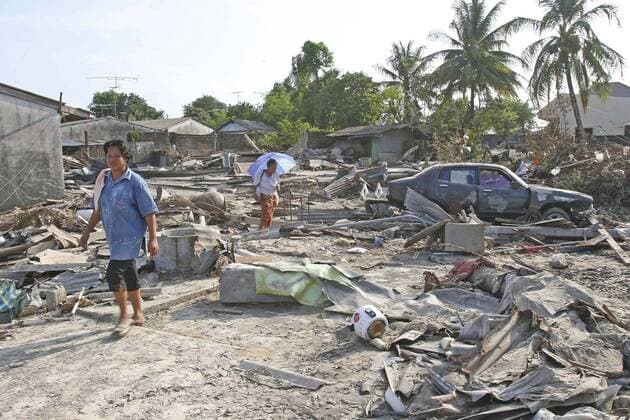 thailand, phang nga district, nam khem, tsunami. thais walk through what is left of there vilage, nothing is left standing in the village of nam kem, about 125kms north of phuket.in phangnga district. on the 31st dec. Copyright: 904_05_20095045
