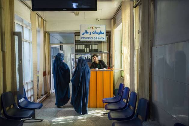 Oct. 22, 2014 - Kabul, Afghanistan - Two women in burka asking worker in Information center of Central Hospital of Afghan Red Crescent Society, Kabul, Afghanistan  - ZUMAn23