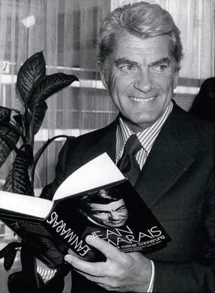 1972 - Frankfurt Book Fair: French actor Jean Marais presents his book Mirror of my Memories The famous French actor Jean Marias has come to the Frankfurt Book Fair where he presents his biography Mirror of my Memories Jean Marias, who has somewhat returned from the stage and film, has turned to pottery. In his house along the Cete d Azur he makes some outstanding figures which are being sold with great success. Our picture: Jean Marais with a copy of his book Mirror of my memories seen at the Frankfurt Book Fair. - ZUMAk09_