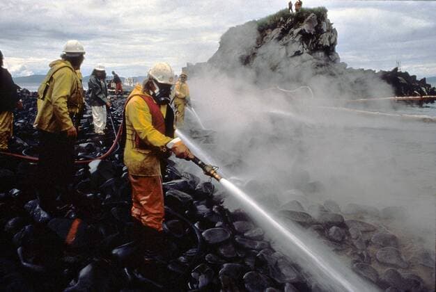 May 25, 2010 - Prince William Sound, AK, United States of America - Workers blast rocks and wash down the shoreline soaked in crude oil using Corexit oil dispersant during a test during clean up operations on Quayle Beach, Smith lsland from the Exxon Valdez oil spill August 8, 1989 in Prince William Sound, Alaska. The Exxon Valdez spilled at least 11 million gallons of crude oil into the pristine waters of Prince William Sound on March 24, 1989. Prince William Sound United States of America - ZUMAp138