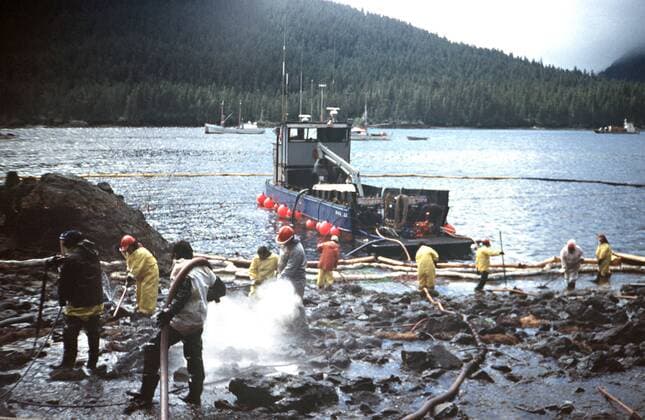 March 28, 1989 - Prince William Sound, AK, United States of America - Workers steam blast rocks and wash down the shoreline soaked in crude oil from the leaking tanker Exxon Valdez after running aground on Bligh Reef in Prince William Sound spilling at least 11 million gallons of crude oil in the pristine waters March 28, 1989 in Prince William Sound, Alaska. Prince William Sound United States of America - ZUMAp138