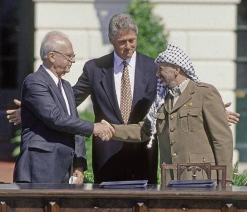Sept. 6, 2015 - Washington, District of Columbia, United States of America - Washington, DC. 9-13-1993.President William Jefferson Clinton hosts the signing of the Oslo Peace accords. Prime Minister Yitzhak Rabin of Israel and the Palestine Liberation Organization chairman, Yasser Arafat, shake hands in a public ceremony at the White House after signing an agreement that granted limited autonomy to Palestine and laid the foundation for future peace talks..Rabin was assassinated by a far right-wing Zionist for his support of the Oslo Accords in November 1995,.Credit: Washington United States of America - ZUMAr142