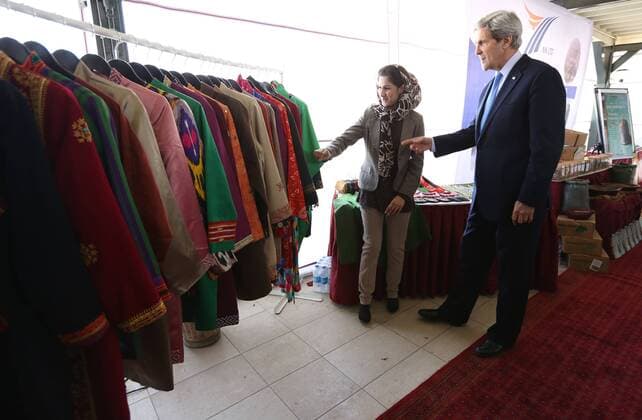 March 26, 2013 - Kabul, Afghanistan - Hassina Aimaq explains her strategy for developing a successful fashion line to US Secretary of State John Kerry during the Taliban regime during a women s business showcase held at the US Embassy March 26, 2013 in Kabul, Afghanistan. Kabul Afghanistan - ZUMAp138