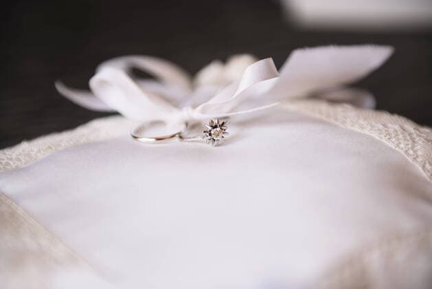 Wedding rings on a white chushion, close-up  GEMF000456