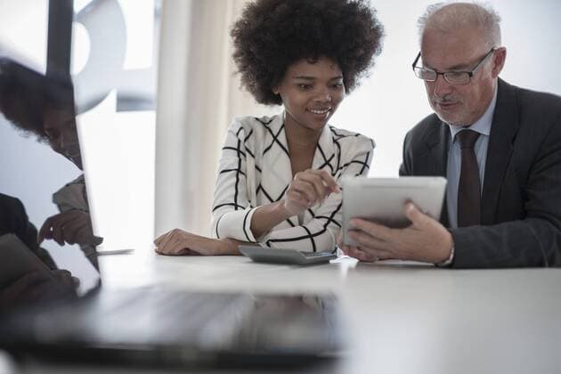 Businessman and woman with digital tablet and calculator model released Symbolfoto property released  ZEF007095