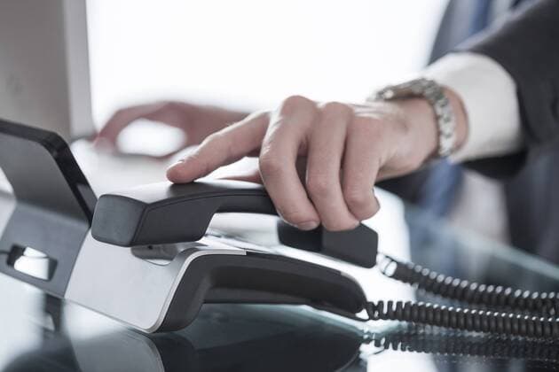 Close-up of man picking up telephone receiver model released Symbolfoto property released  ZEF007116