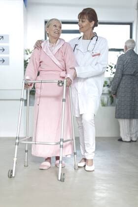 Model Released: Senioren im Krankenhaus Doctor leading elderly patient with walking frame on hospital floor model released Symbolfoto property released  ZEF007237