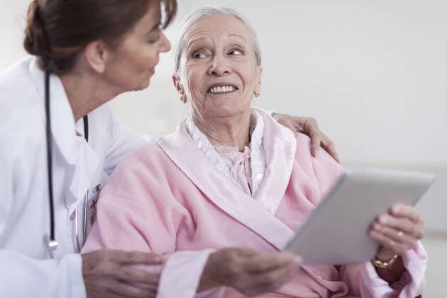 Model Released: Senioren im Krankenhaus Doctor and smiling elderly patient in wheelchair with digital tablet model released Symbolfoto property released  ZEF007246