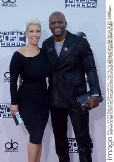 Actor Terry Crews, right, and wife Rabecca King-Crews arrive for the 43rd annual American Music Awards held at Microsoft Theater in Los Angeles on November 22, 2015.  LAP20151122276 JIMxRUYMEN