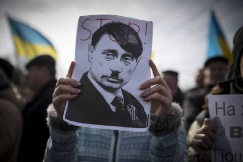 March 9, 2014 - Simferopol, Crimea, Ukraine - Russian President Putin is portrayed as Hitler at a pro-Ukraine rally in Simferopol, Ukraine s autonomous republic of Crimea. The Supreme Council of Crimea decided on Thursday to hold a referendum March 16 on whether Crimea stays an autonomous region of Ukraine or will join the Russian Federation.  - ZUMAb13