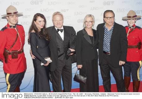 Mar 30, 2014 - Winnipeg, Manitoba, Canada - Bachman-Turner Overdrive band members Robbie Bachman (L) and Blair Tornton and their spouses arrive on the Red Carpet of the 2014 Juno Awards at the MTS Centre. - ZUMAr88