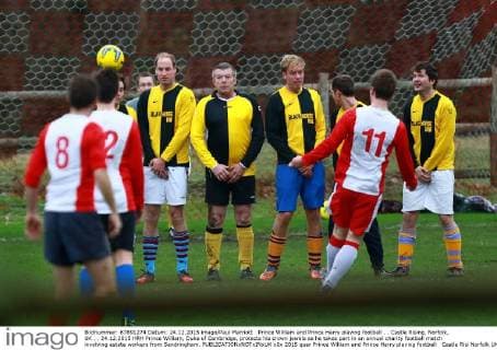 Prince William and Prince Harry playing football . . Castle Rising, Norfolk, UK . . 24.12.2015 HRH Prince William, Duke of Cambridge, protects his crown jewels as he takes part in an annual charity football match involving estate workers from Sandringham. 