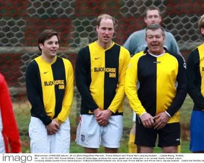 Prince William and Prince Harry playing football . . Castle Rising, Norfolk, UK . . 24.12.2015 HRH Prince William, Duke of Cambridge, protects his crown jewels as he takes part in an annual charity football match involving estate workers from Sandringham. 