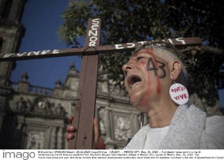 (151227) -- MEXICO CITY, Dec. 26, 2015 -- A protestor takes part in a march remembering the 43 missing students from the Isidro Burgos rural teachers college in Mexico City, capital of Mexico, Dec. 26, 2015. The march took place one year and three months after several students and bystanders were killed and 43 students vanished in the city of IgualaAlejandro Ayala) MEXICO-MEXICO CITY-MISSING STUDENTS-MARCH e AlejandroxAyala 