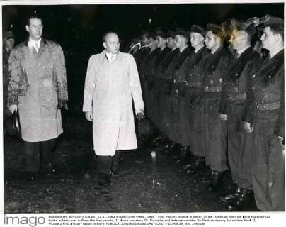 1958 - First military parade in Bonn: To the transition from the Bundesgronschutz to the military was in Bonn the first parade. 1) Home secretary Dr. Schroder and defense minister Ih-Blank reviewing the solders front. 2) Picture 2 First military tattoo in Bonn. - ZUMAk09_