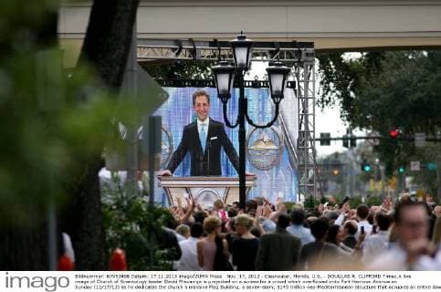Nov. 17, 2013 - Clearwater, Florida, U.S. - DOUGLAS R. CLIFFORD Times.A live image of Church of Scientology leader David Miscavige is projected on a screen for a crowd which overflowed onto Fort Harrison Avenue on Sunday (11 17 13) as he dedicates the church s massive Flag Building, a seven-story, $145 million neo-Mediterreanean structure that occupies an entire downtown block in downtown Clearwater. The church expected the private event to draw 10,000 Scientologists highlighting more than a week of celebrations, including seminars, banquets and presentations for the church, which has requested street and sidewalk closures, police protection and other city services. - ZUMAs70