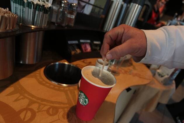 Wuppertal Mann r?hrt einen Kaffee im Pappbecher in einem Starbucks mit einem Holzstaebchen um, 29.12..2015, Copyright: Deutzmann Eibner-Pressefoto EP_CDN