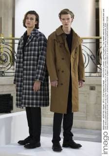 . 09 01 2016. London, United Kingdom. Two models wearing a block check wool coat (left) and a rubberized traditional mac at the Mackintosh show on day two of London Men s Fashion Week for autumn winter 2016.  xStephenxLockx xi-Imagesx IIM-11693-0005