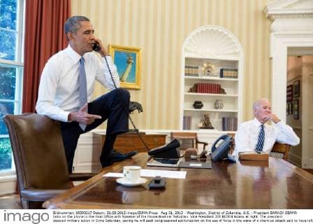 Aug 31, 2013 - Washington, District of Columbia, U.S. - President BARACK OBAMA talks on the phone in the Oval Office with Speaker of the House Boehner Saturday. Vice President JOE BIDEN listens at right. The president delayed military action in Syria Saturday, saying he will seek congressional authorization on the use of force in the wake of a chemical attack said to have left some 1,400 civilians dead. Congressional approval could prove difficult, as members of both parties and many in the public have expressed uneasiness with the idea of a military campaign. - ZUMAz03