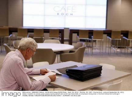 Sept. 26, 2012 - Wichita, KS, USA - Charles Koch, pictured September 26, 2012, takes a moment to review some papers during a brief visit to the new Koch Cafe, an employee dining area in the Koch Industries building in Wichita, Kansas. - ZUMAm67