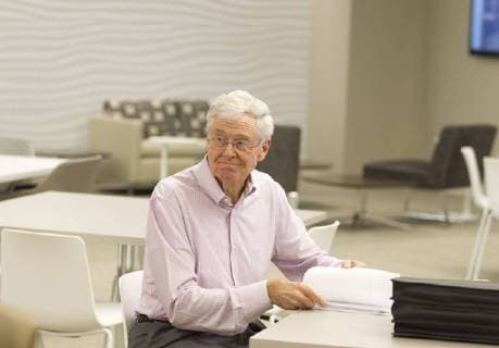 Sept. 26, 2012 - Wichita, KS, USA - Charles Koch, pictured September 26, 2012, takes a moment to review some papers during a brief visit to the new Koch Cafe, an employee dining area in the Koch Industries building in Wichita, Kansas. - ZUMAm67