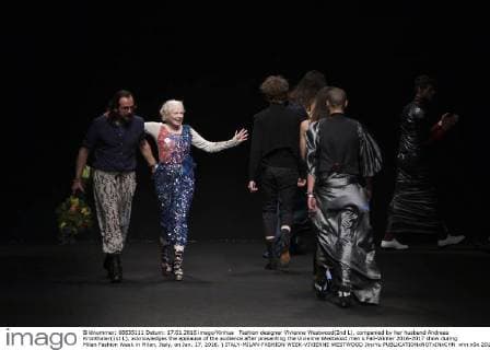 Fashion designer Vivienne Westwood(2nd L), companied by her husband Andreas Kronthaler(1st L), acknowledges the applause of the audience after presenting the Vivienne Westwood men s Fall-Winter 2016-2017 show during Milan Fashion Week in Milan, Italy, on Jan. 17, 2016. ) ITALY-MILAN-FASHION WEEK-VIVIENNE WESTWOOD JinxYu 