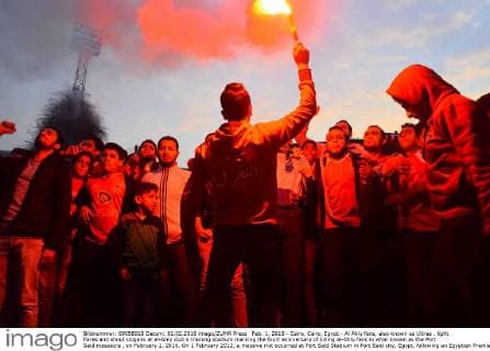 Feb. 1, 2016 - Cairo, Cairo, Egypt - Al Ahly fans, also known as Ultras , light flares and shout slogans at al-Ahly club s training stadium marking the fourt anniversary of killing al-Ahly fans in what known as the Port Said massacre , on February 1, 2016. On 1 February 2012, a massive riot occurred at Port Said Stadium in Port Said city, Egypt, following an Egyptian Premier League football match between El Masry and El Ahly clubs. At least 74 people were killed and more than 500 were injured after thousands of El Masry spectators stormed the stadium stands and the pitch Cairo Egypt - ZUMAap3_