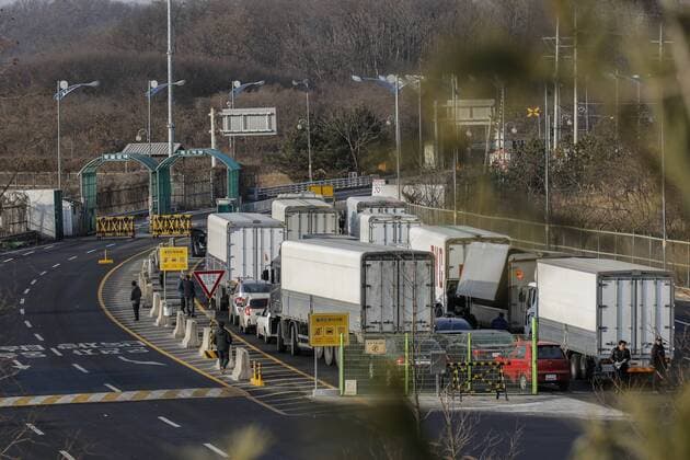 Feb. 11, 2016 - Paju, Gyeonggi, South Korea - South Korean cargo trucks head to the North Korean city of Kaesong as South Korean Army soldiers stand guard at the customs, immigration and quarantine office near the border village of Panmunjom in Paju, South Korea. South Korea said Wednesday that it will shut down a joint industrial park with North Korea in response to its recent rocket launch, accusing the North of using hard currency from the park to develop its nuclear and missile programs. Paju South Korea  - ZUMAn230