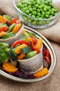 Pickled herring rolls with vegetables. Party dish  bew1A9F75B