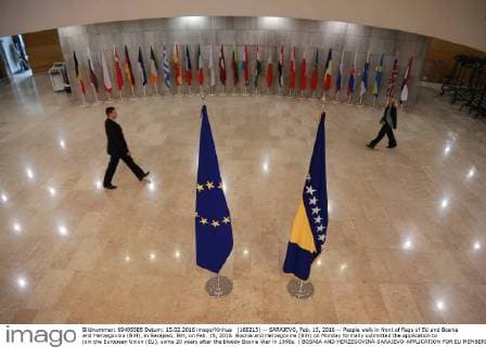 (160215) -- SARAJEVO, Feb. 15, 2016 -- People walk in front of flags of EU and Bosnia and Herzegovina (BiH), in Sarajevo, BiH, on Feb. 15, 2016. Bosnia and Herzegovina (BiH) on Monday formally submitted the application to join the European Union (EU), some 20 years after the bloody Bosnia War in 1990s. ) BOSNIA AND HERZEGOVINA-SARAJEVO-APPLICATION FOR EU MEMBERSHIP HarisxMemija 