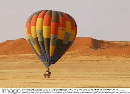 Hot air balloon landing after ride over the Namib desert, Namibia, February 2005.  1451059 EnriquexLopez-Tapia